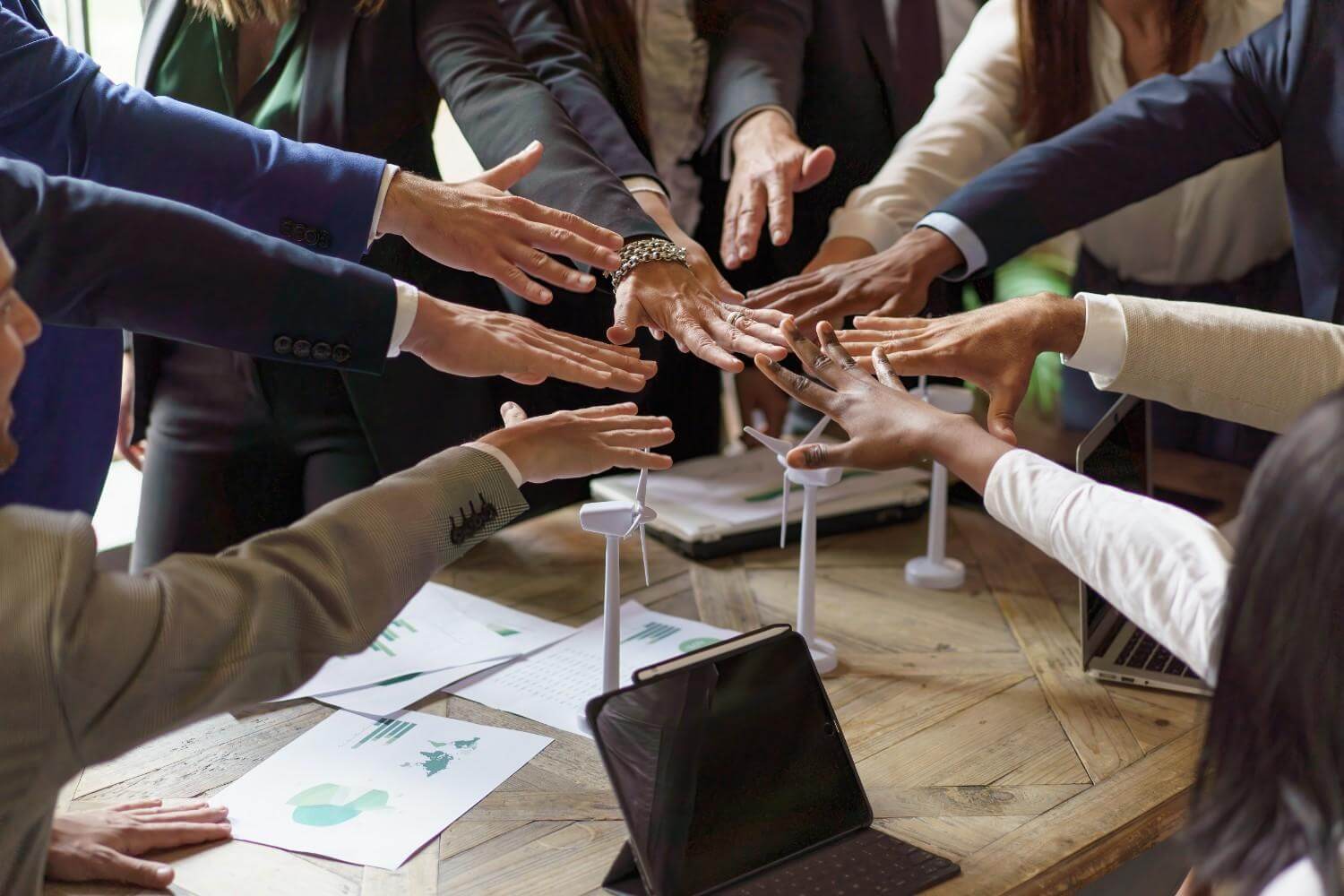 Diverse professional team collaborating renewable energy project success