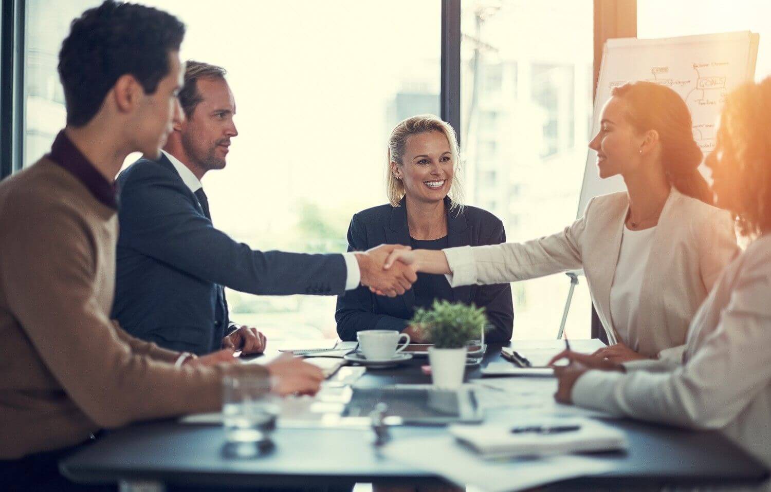 Business professionals networking and shaking hands during corporate meeting