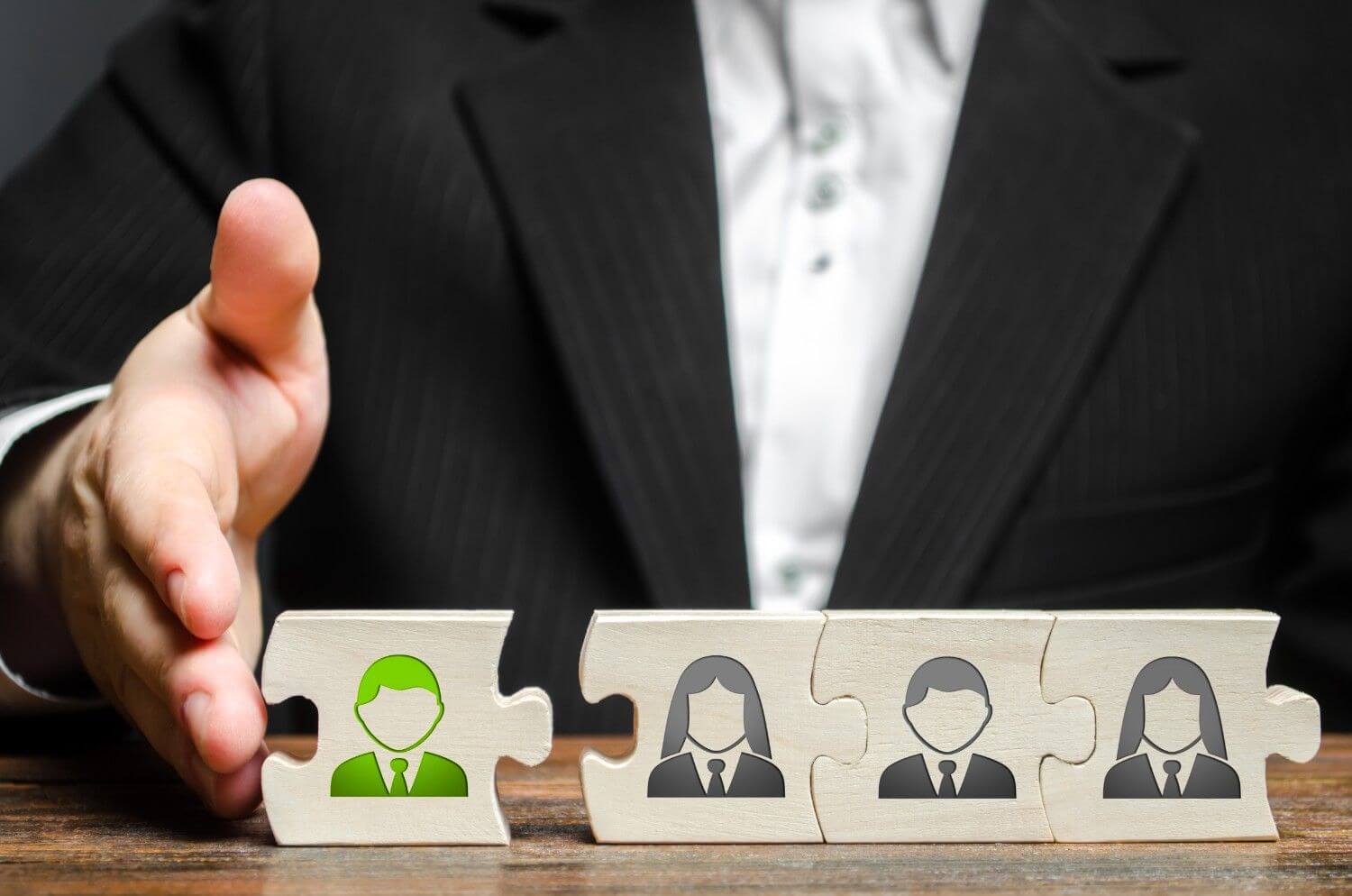 Business leader integrating new employee puzzle piece into professional team