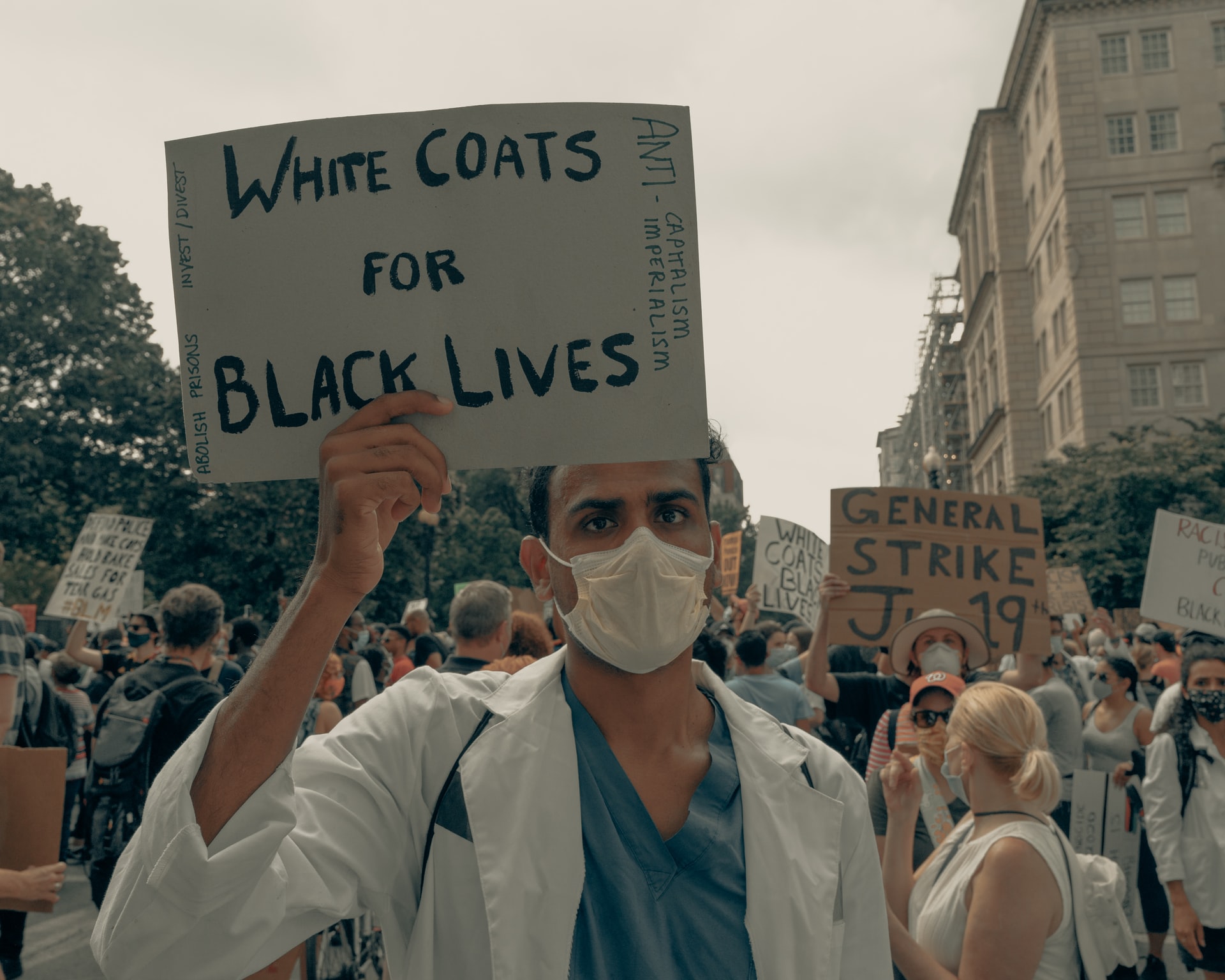 Doctor holds up sign at the Black Lives Matter protest in Washington DC
