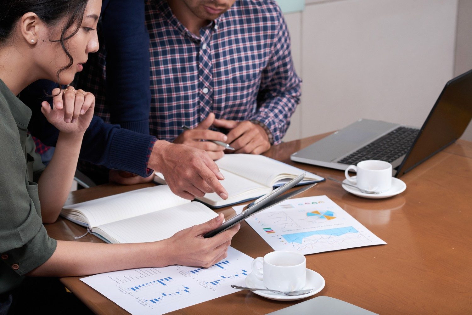 Business people discussing charts and diagrams in an office