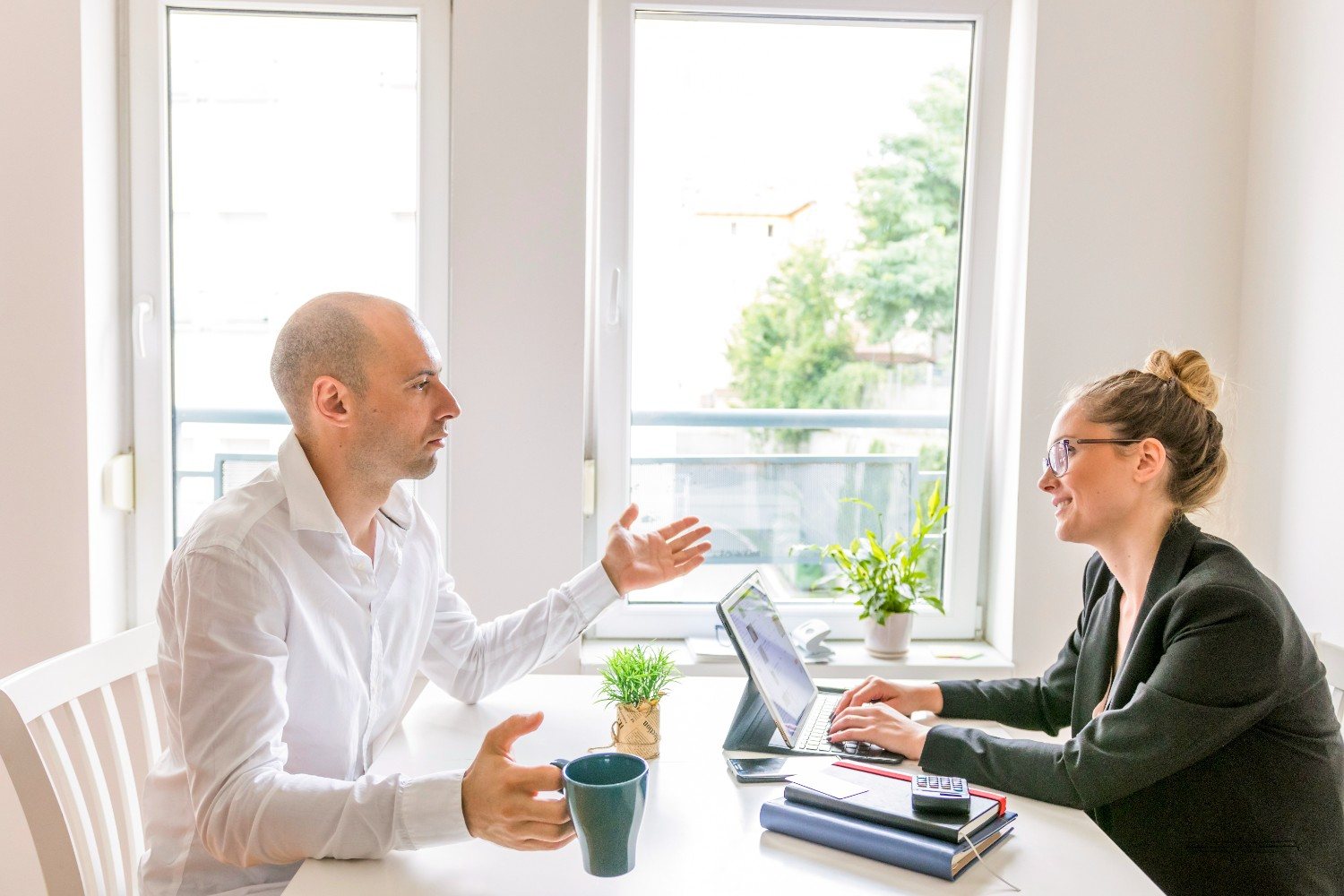 Two businesspeople having a conversation in an office