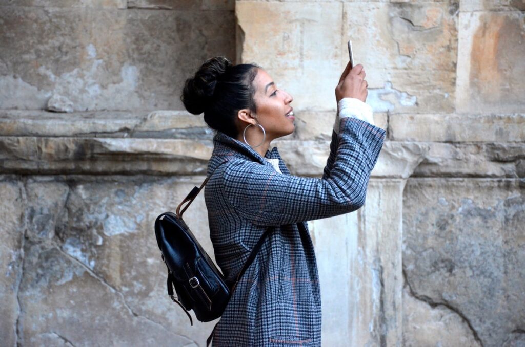 Woman blue plaid coat holding her phone 1024x678