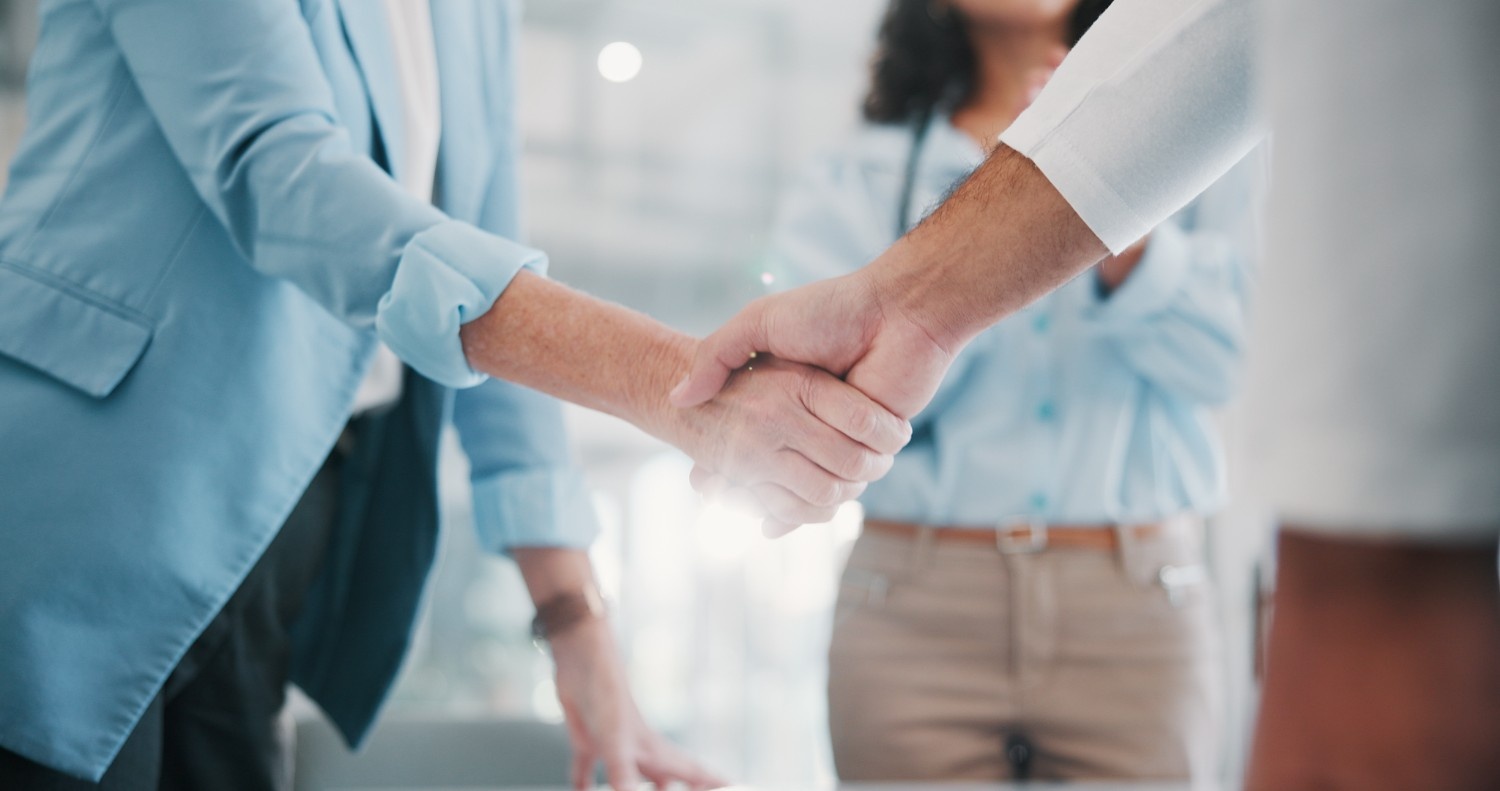 Corporate professionals shaking hands on an agreement
