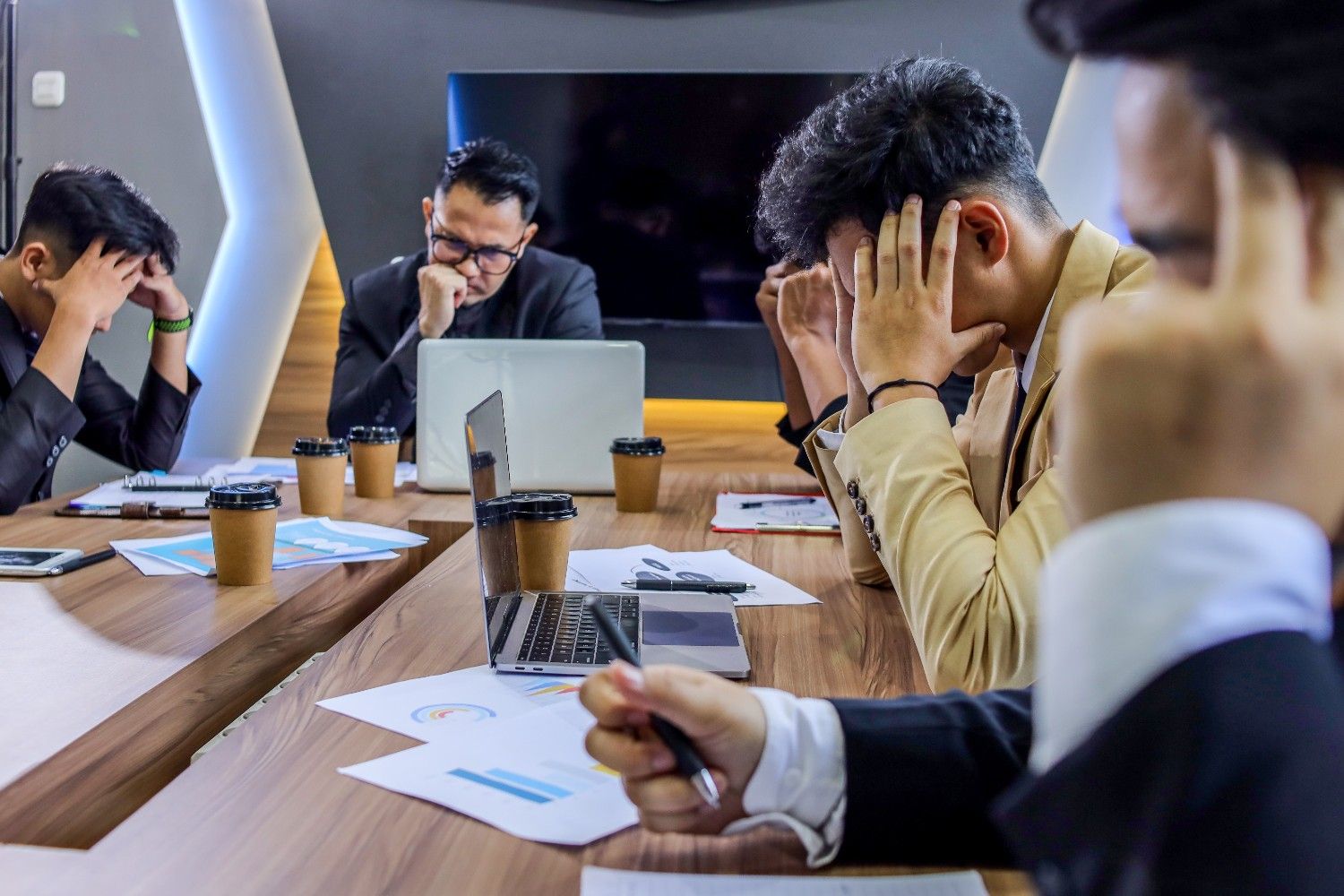 Stressed business team overwhelmed at meeting