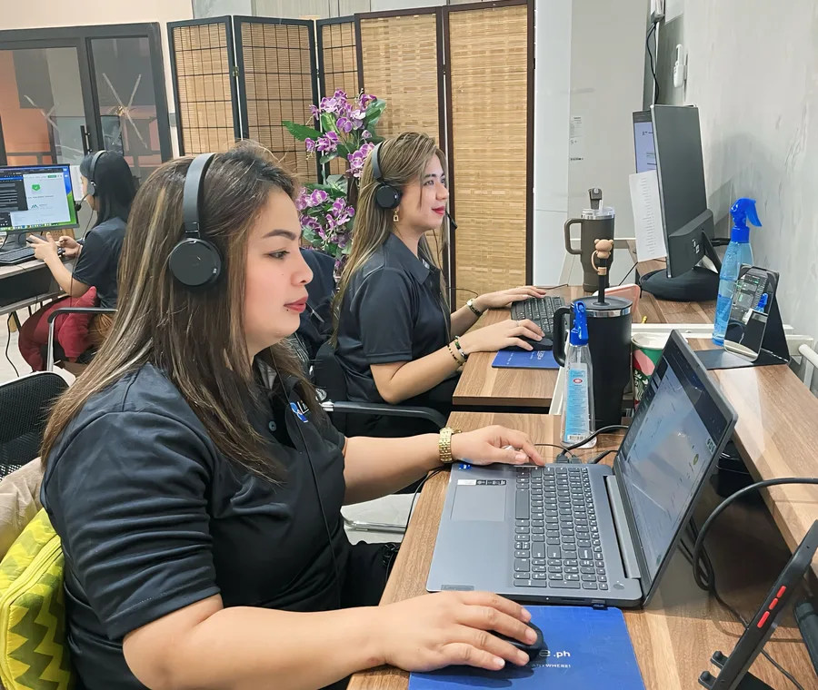 Murphy support specialists working tickets on headsets at their desks