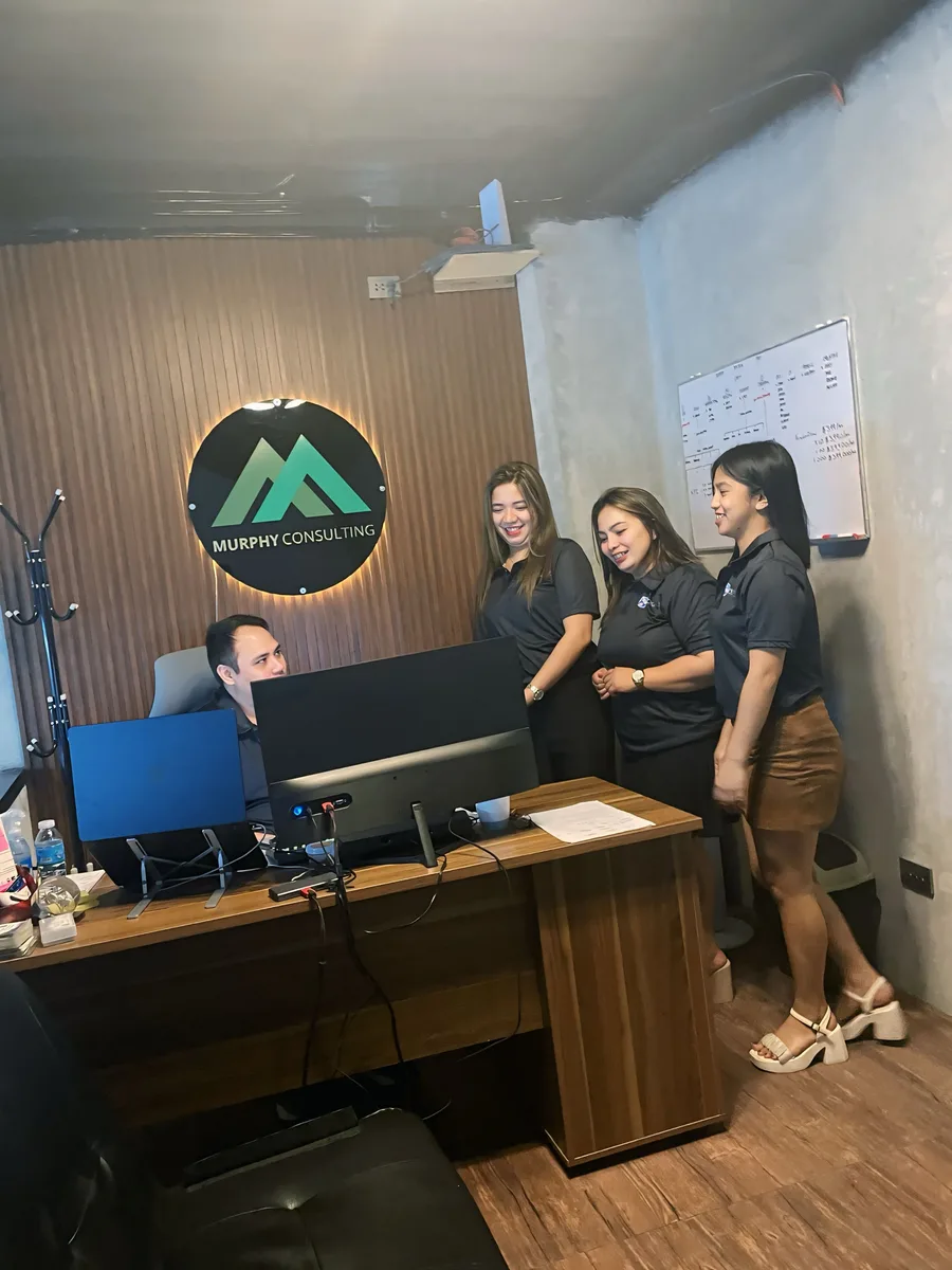 Murphy production team gathered at a desk reviewing an issue on screen